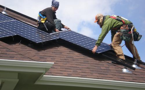 Minnesota solar workers install residential solar energy array MnSEIA policy